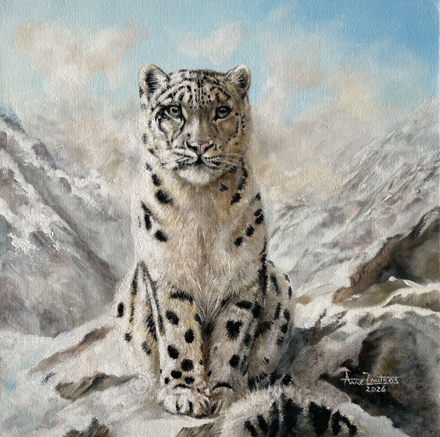 A snow leopard sitting on a snowy mountainside