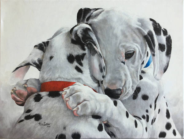 Two Dalmatian puppies embracing