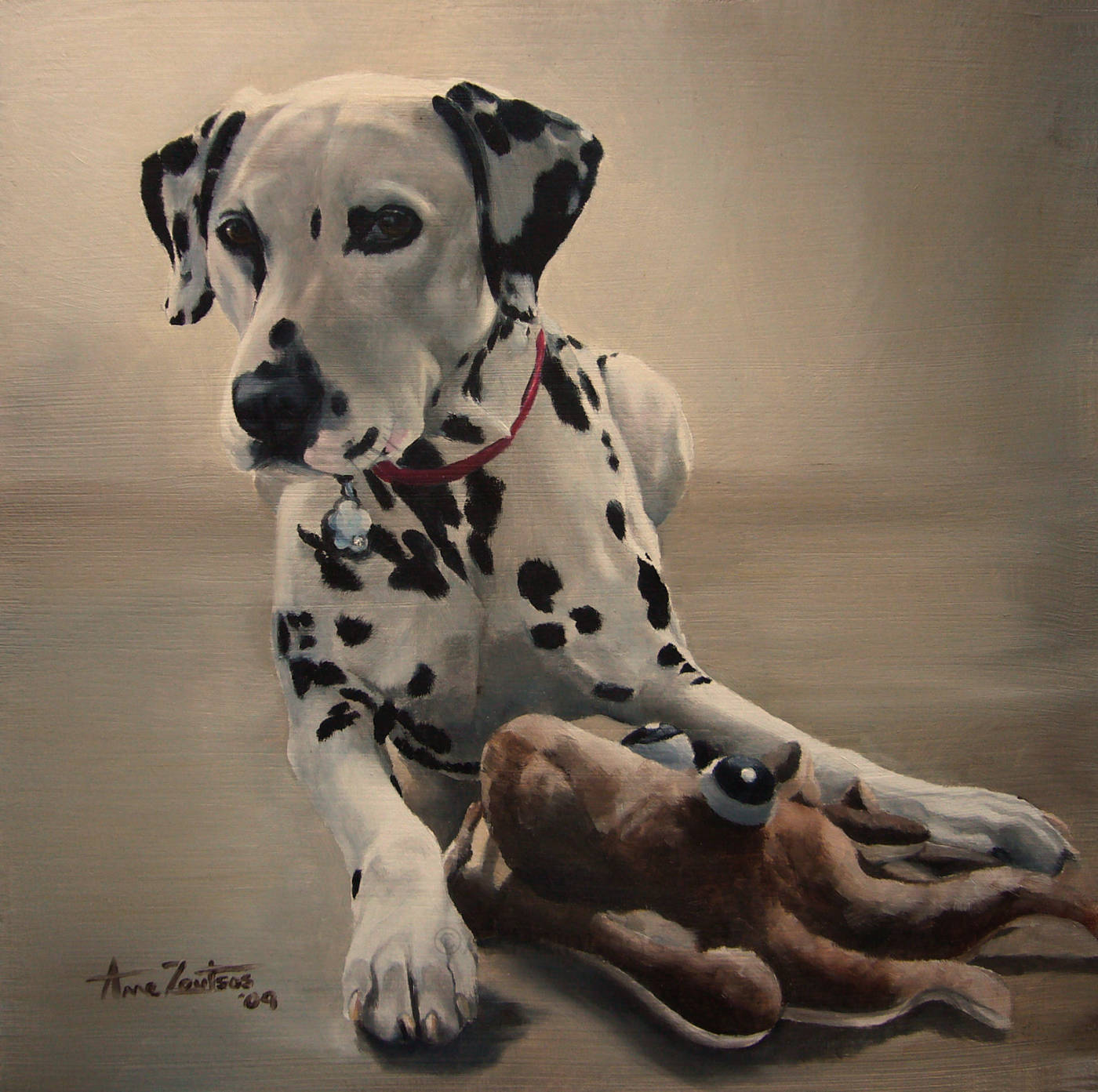 A Dalmatian wearing a red collar with one of her favourite soft toys